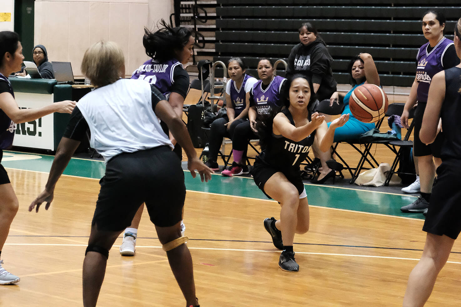 Tritons player Amarah San Nicolas shuffle passes the ball to a teammate. 