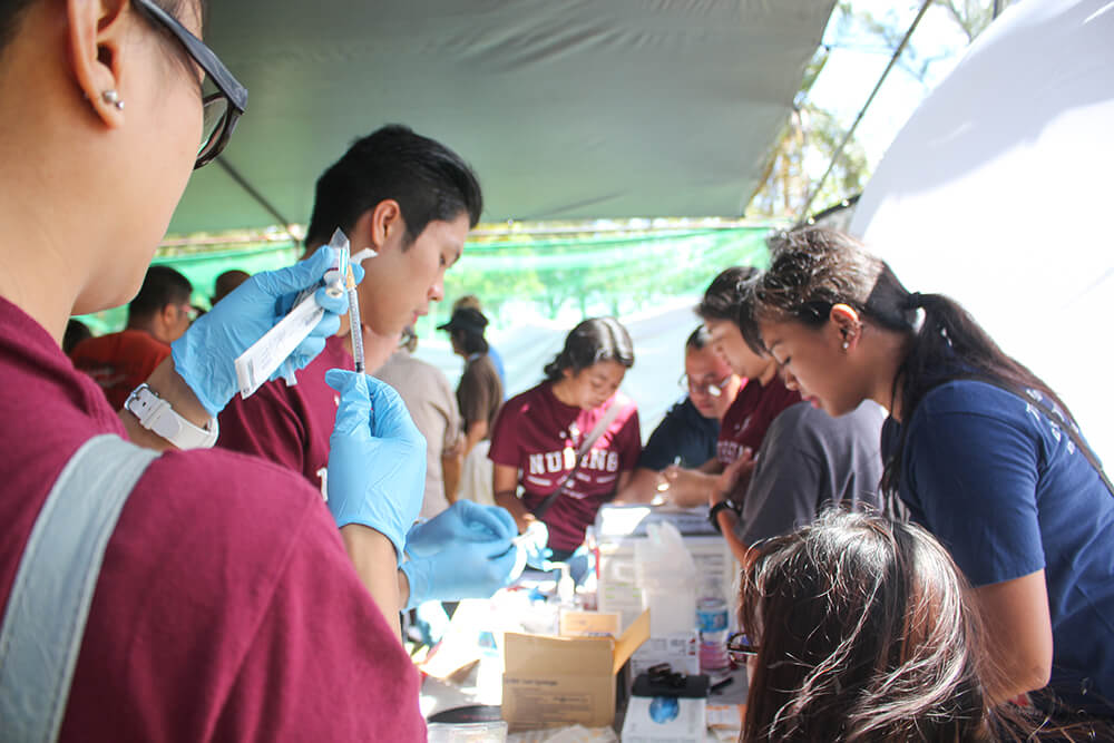 Students prepare to provide health services for the homeless at an outreach event.