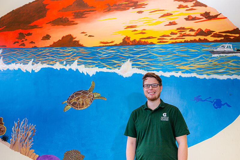 Graduate student Justin Berg is in the process of completing a mural in the Marine Lab boat shop