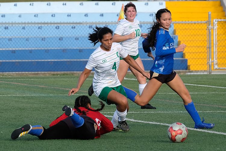 The Triton Women’s Soccer Team in a game against Guam Women’s Shipyard.