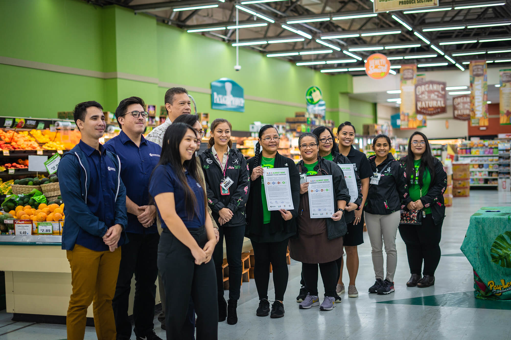 The managers of Pay-Less Markets Inc. show their newly signed pledges alongside staff