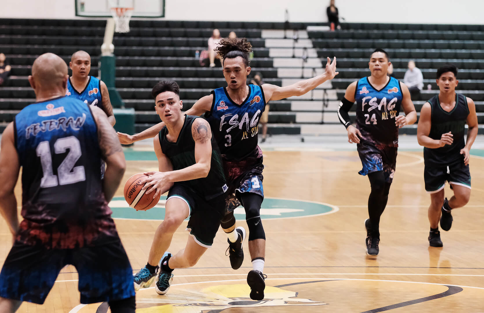 Michael Quan of the UOG Tritons powers past defenders. Quan scored 33 points in the game on Nov. 13.