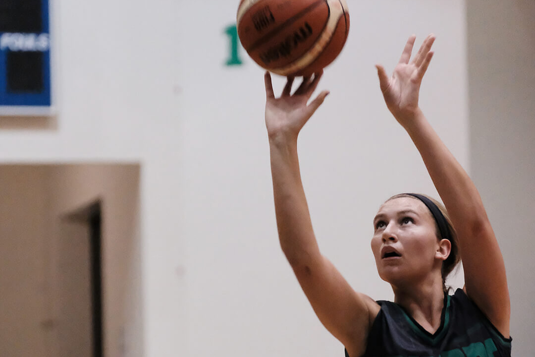 The Tritons’ Paige Persha hits a 3-point basket early in the first quarter.