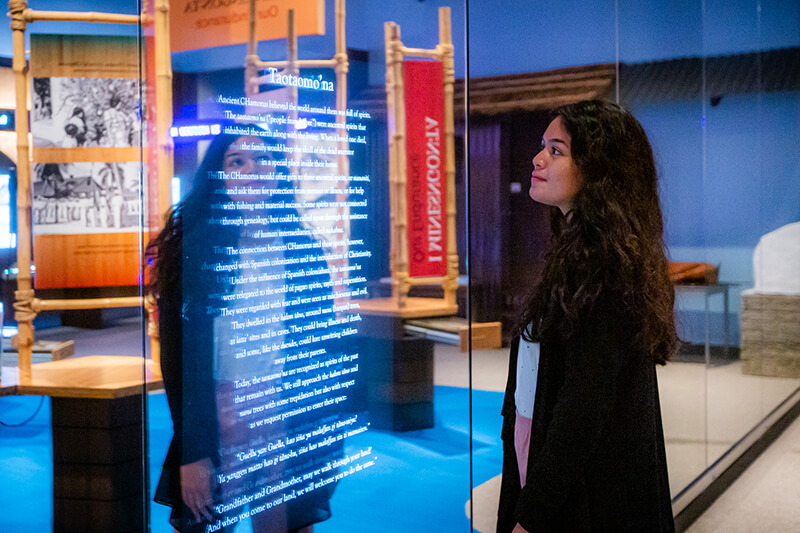 Perez reads about ancient CHamoru beliefs in the Guam Museum