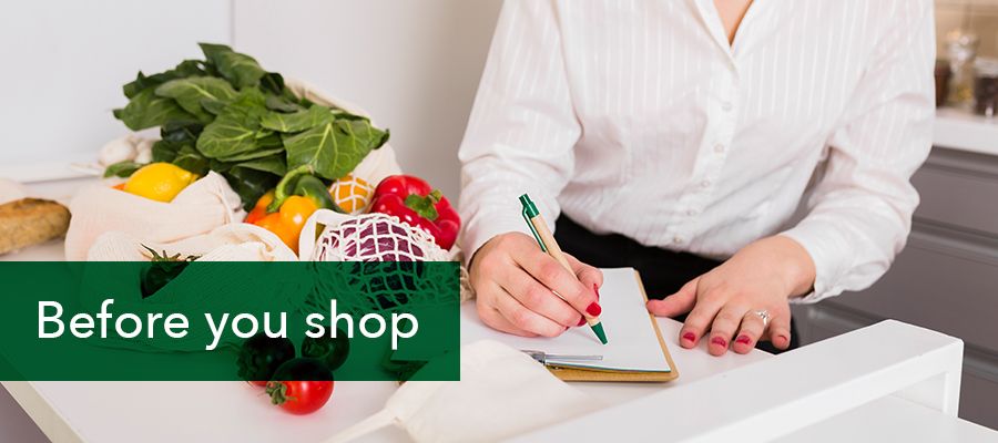 Photo of a lady making a grocery check list