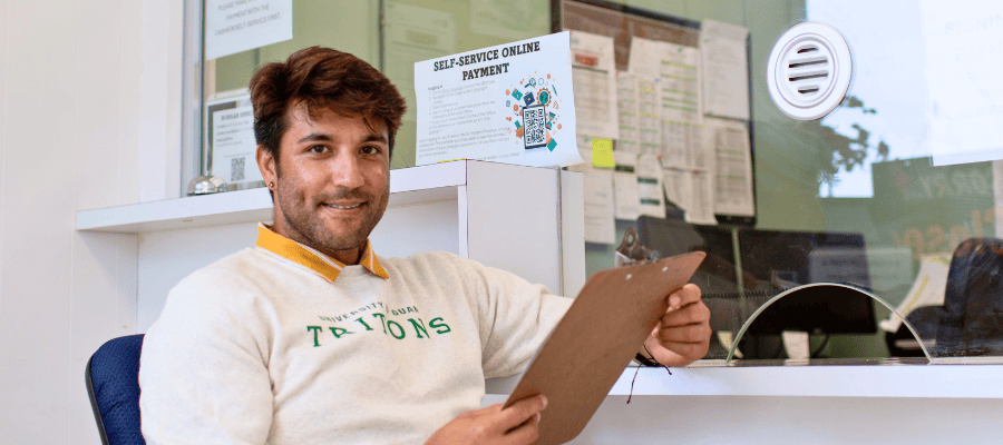 Photo of a Triton male student holding a clipboard