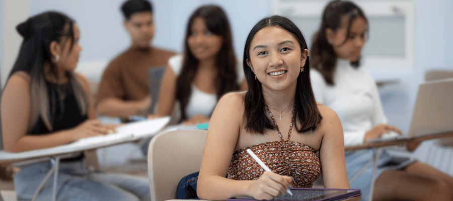 Photo of a female student in class.