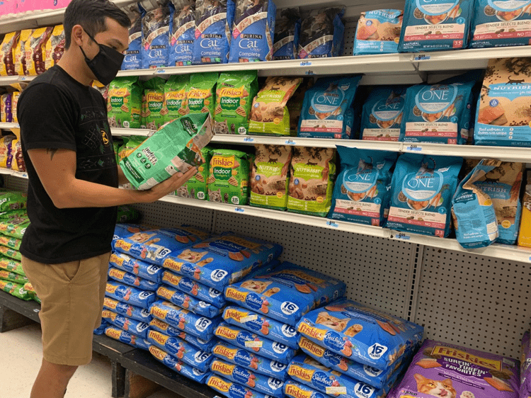 Photo of a someone picking out cat food