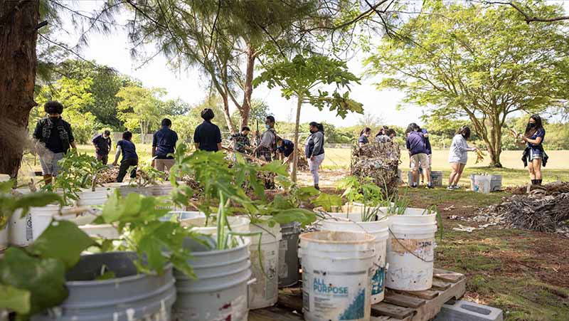 Students at F.B. Leon Guerrero Middle School prepare to plant various trees and plants 