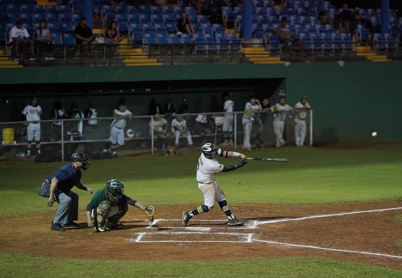 Tritons' Kolby Martinez hits a line drive in a Guam Major League playoff game against the Talofofo Rangers.