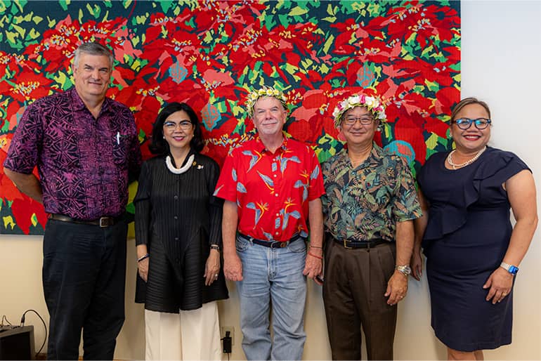 David S. Okada, James R. Hollyer and others pose for a photo at farewell gathering