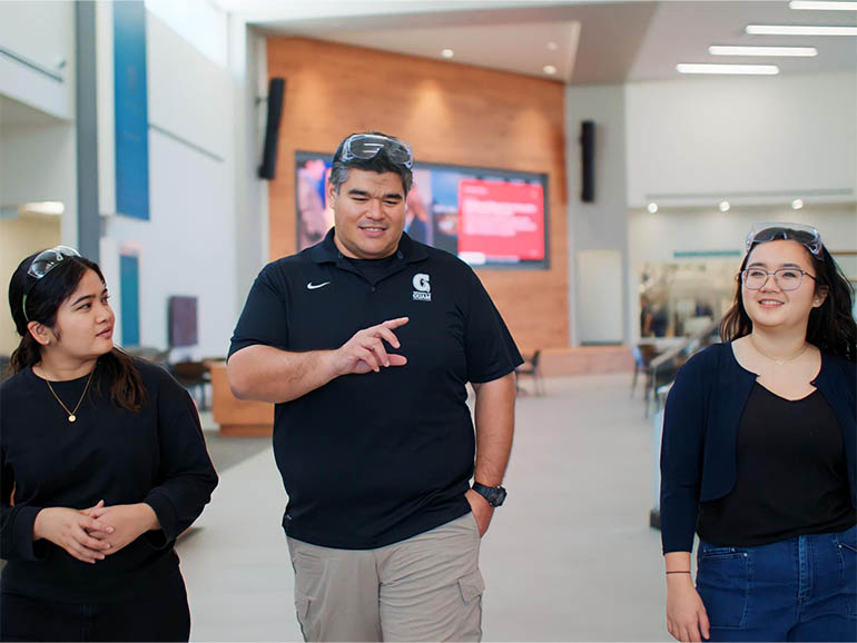 John Limtiacro walks with UOG engineering students at Pacific Northwest National Laboratory in Washington.