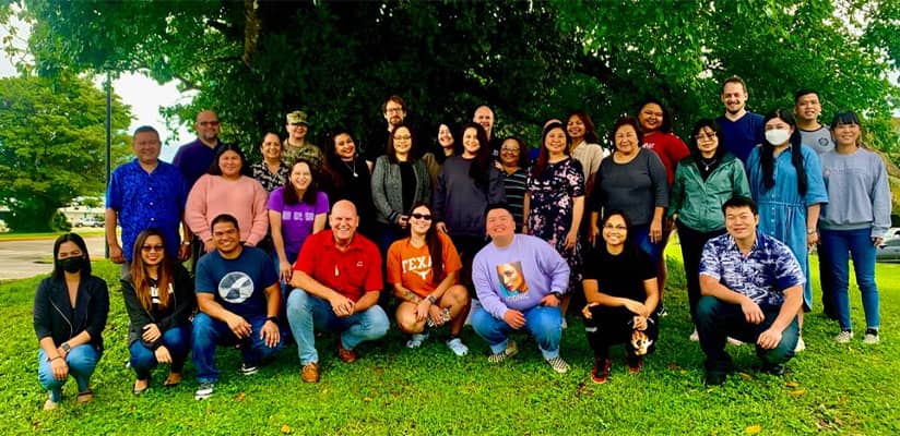 Dr. Kirk Johnson pose with other educators and contributors to new book