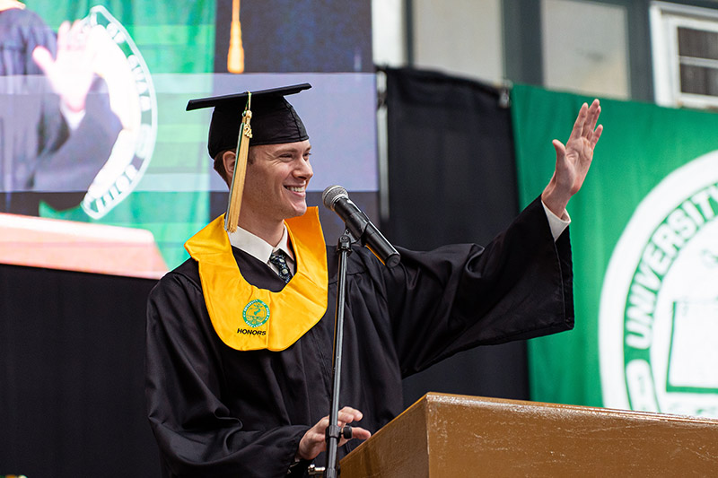 Photo of Hunter Sidell speaking at the graduation podium