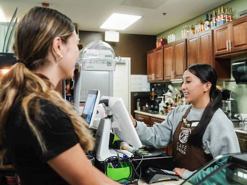 A female Triton student working as a barista at the UOG Cafe Sirena