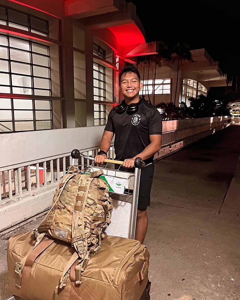 Photo of Lidio Fullo pushing a luggage cart at an airport