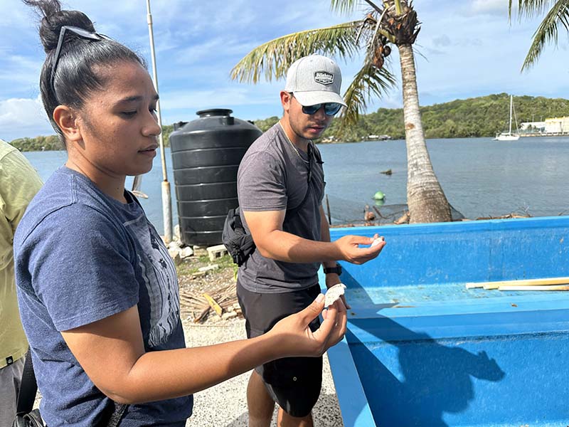 Photo of two people examining a clam