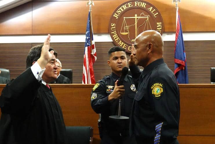 Chief Justice Robert Torres swears in Leo Diaz as the marshal of the courts on Nov. 25, 2024.