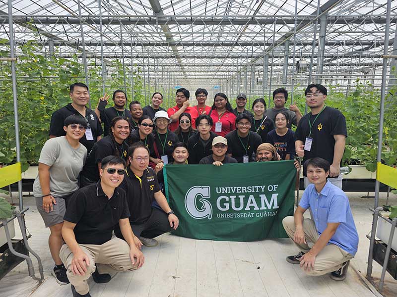 Photo of a group of students in a greenhouse