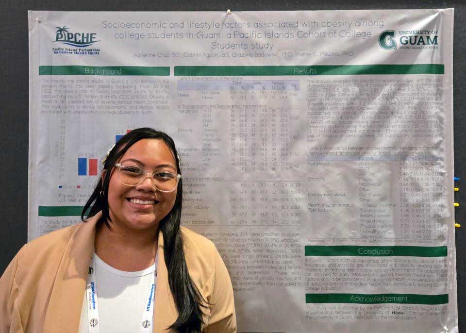 Woman standing next to a research poster