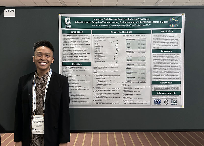 Man standing next to a research poster