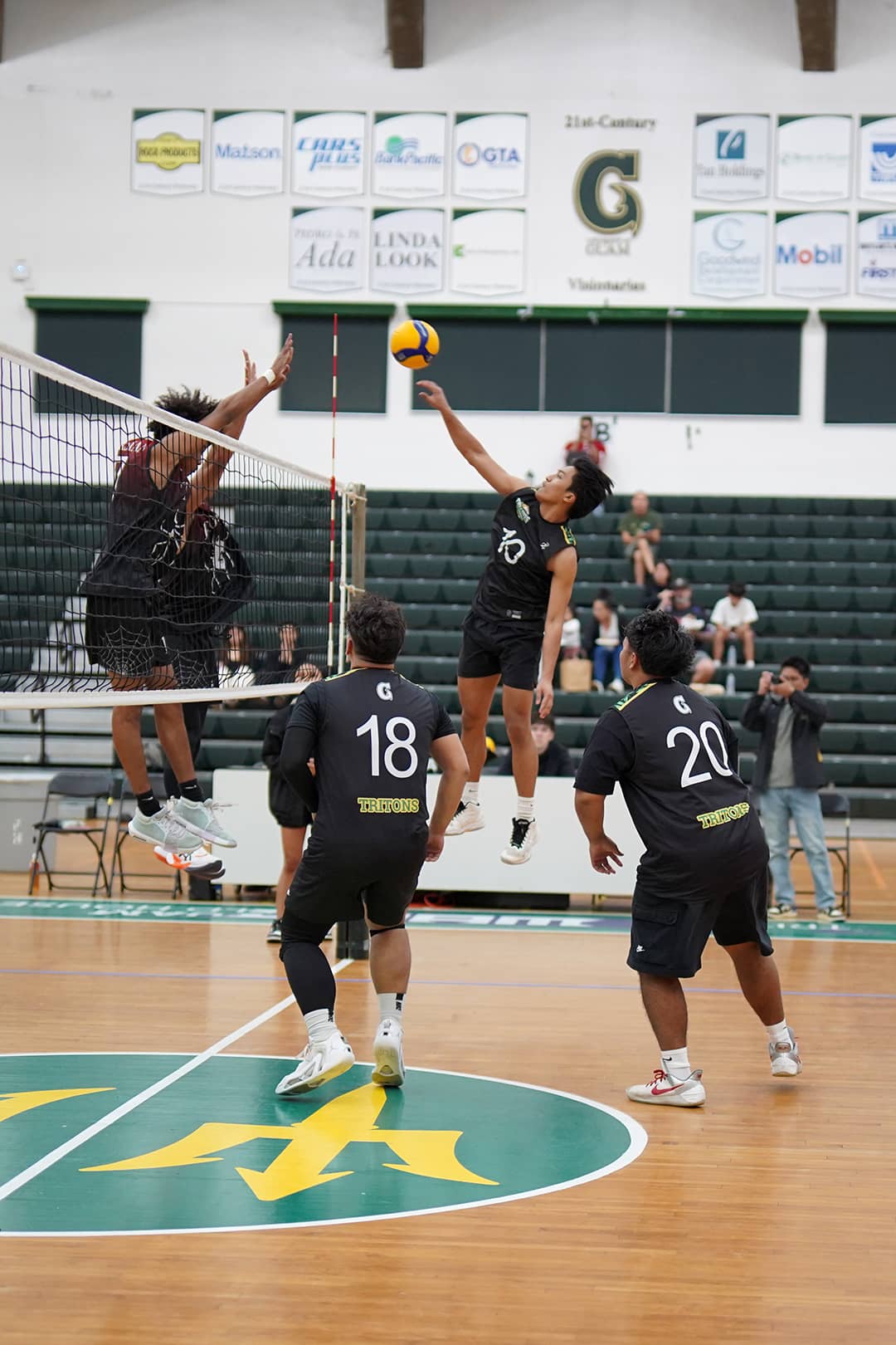 Toupe and tritons playing volleyball