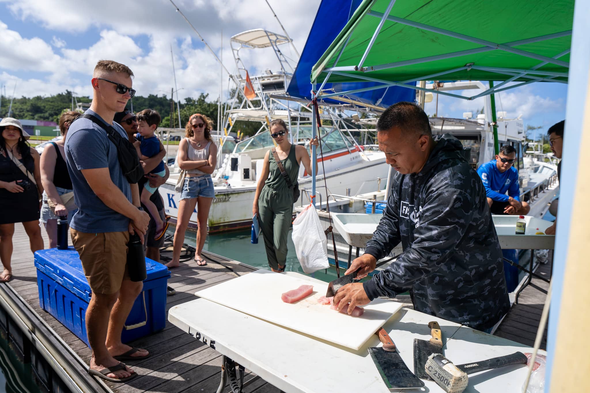 Fish Fest featured a Walk on the Dock element that welcomed attendees to take a tour of local business fishing boats and the facilities at the Hagatna Boat Basin.  Dino Macaraeg from Reel Fishing Charters answered questions and talked about commercial fishing on Guam.  He also provided samples of fresh mahi sashimi.