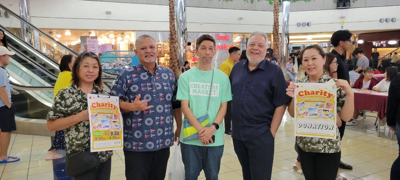 Students from the Niigata College of Art and Design pose with Carlos Taitano, Director of UOG’s Global Learning and Engagement (second row, fourth from right) and James D. Sellmann, Dean of UOG’s College of Liberal Arts and Social Sciences (second row, fifth from right) at the annual Charity Art and Craft Market benefitting UOG’s Fine Arts program.