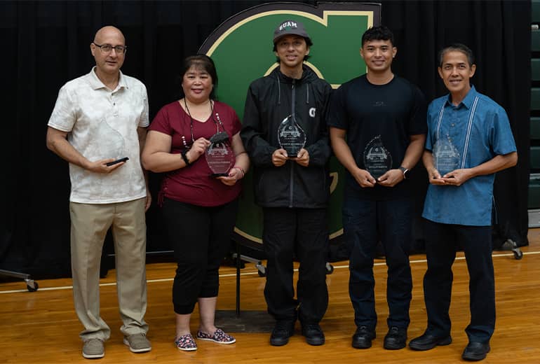 Newest Athletic Hall of Fame members pose for a photo in front of big G