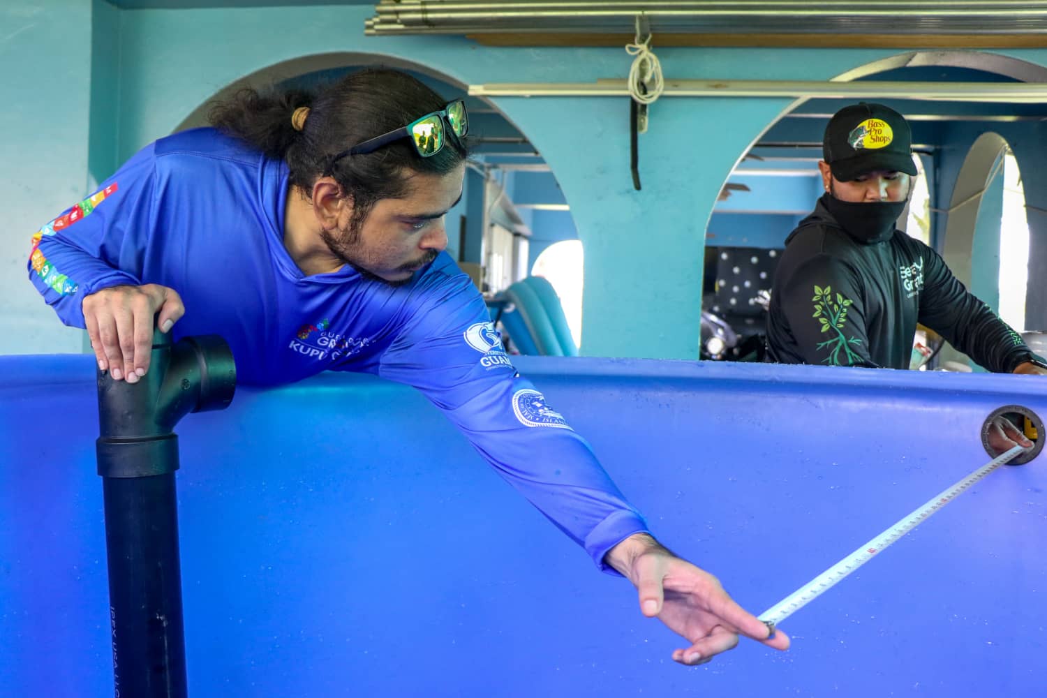 UOG's Lawrence Lizama and Joshua Muña prepare to install the first Community-Based Aquaponics System.