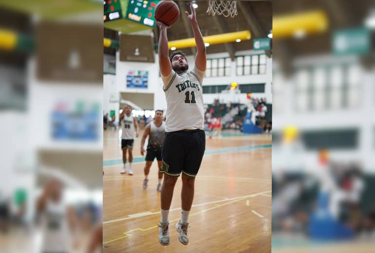 UOG Triton Isaac Orlando shoots basketball into hoop