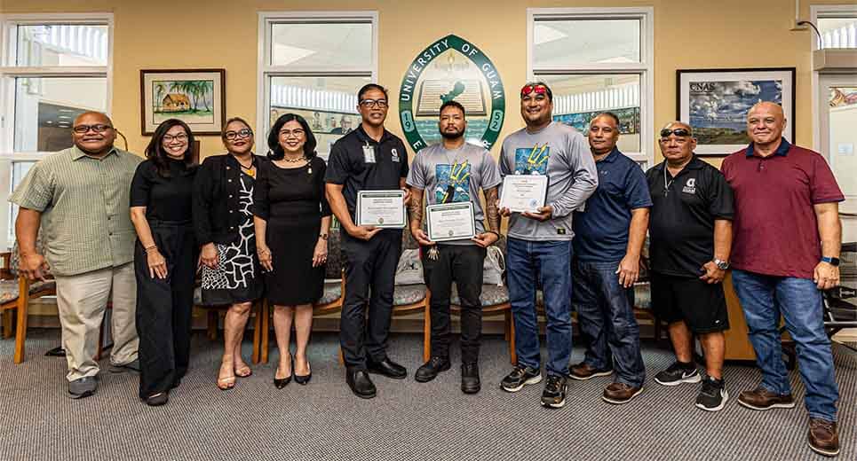 UOG president and admin pose for a photo with newly certified HVAC Journeymen